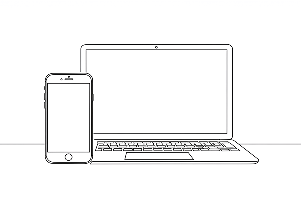 ノートパソコンとスマホが並んでいる